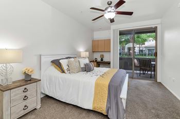 Bedroom with patio access and ceiling fan
